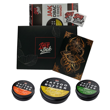 A collection of Love Ink tattoo care products displayed on a transparent background. The items include a black box with the Love Ink logo, a brochure on how to care for a new tattoo, a sticker, a black and gold tattoo design, and three tins of Tattoo Butter in different formulations for daily care.