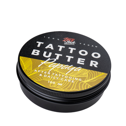 Close-up of a 100ml jar of Tattoo Butter Papaya by LoveInk. The product features a black and yellow design, emphasizing its use for after tattooing and daily care.